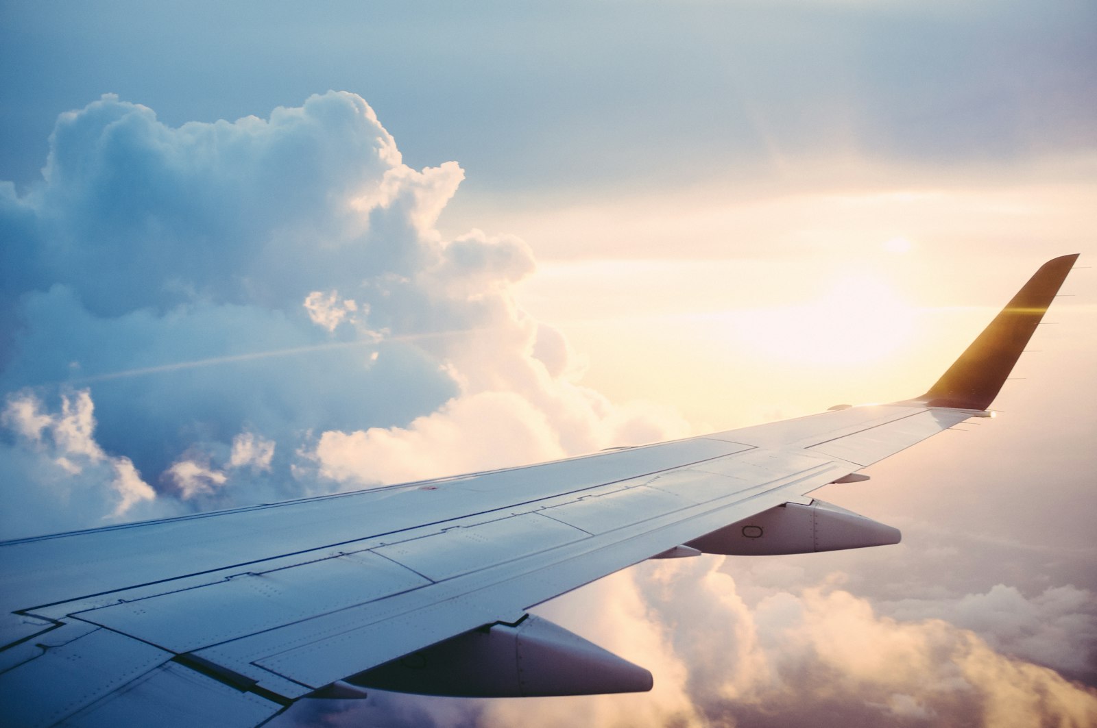 Aircraft wing above the clouds during international travel
